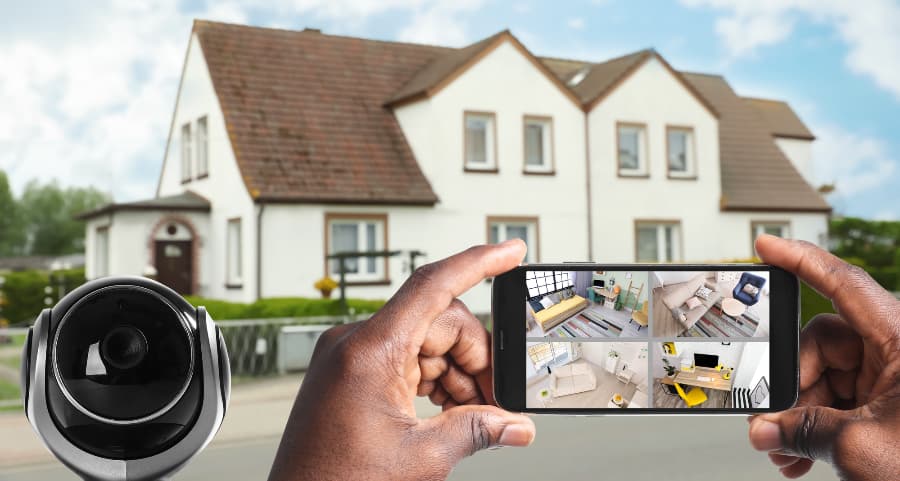 Man holding phone and checking footage from security cameras